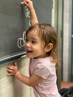 Sora writing on a chalk board.