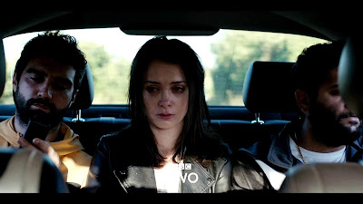 Ana (Anca Dumitra) is kidnapped off the streets of London and shoved into a car by two men (Sergiu Costache and Alec Secareanu) in movie still for the BBC TV films Doing Money