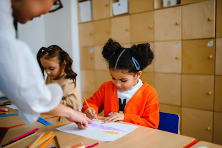 A child in a classroom with a teacher