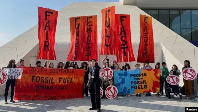 Climate activists protest after a draft of a negotiation deal was released, at the United Nations Climate Change Conference COP28 in Dubai, United Arab Emirates, Dec. 13, 2023.