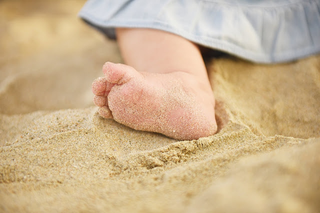 little girls toes in the sand in Huntington Beach