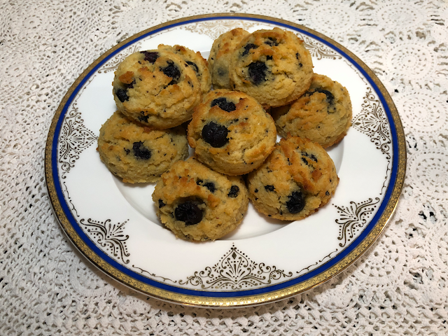 Baked blueberry "biscones" on plate on lace tablecloth