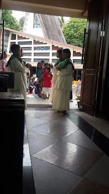 waiting blessing from priest by the children in the isle