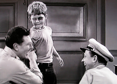 Opie shows his black eye to father Andy and Barney in Andy Griffith TV show 1961