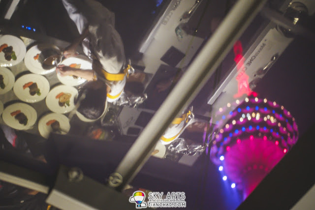 A reflection of our chef preparing our main course with KL Tower as background