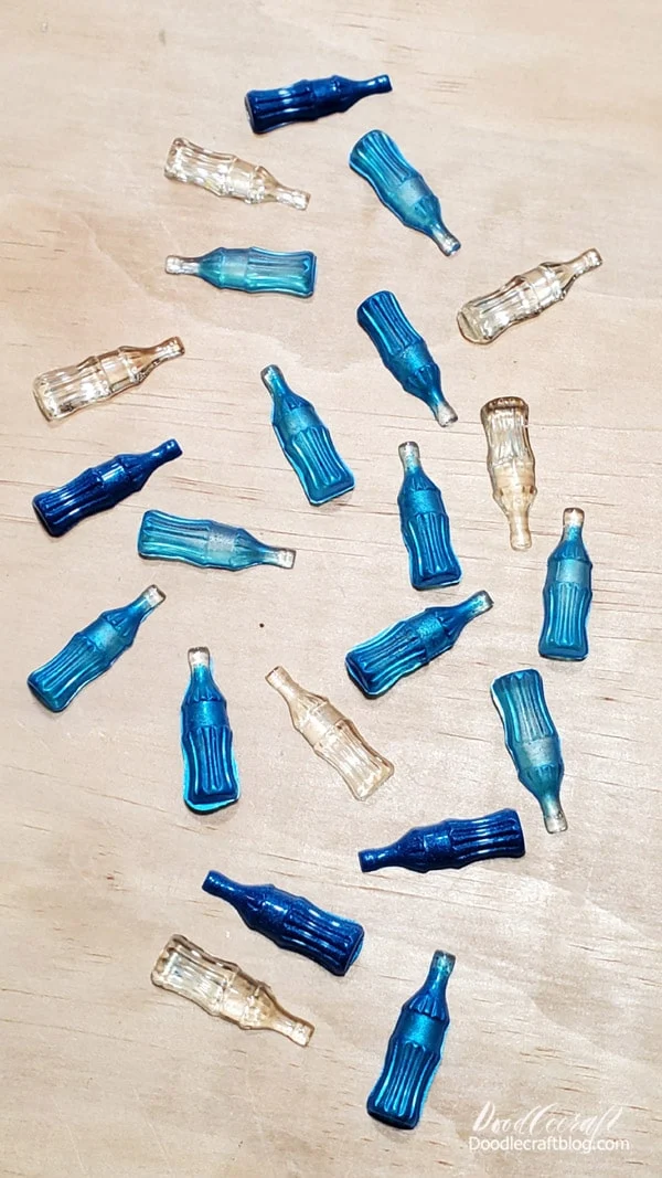 I made some resin cola bottles with blue mica powder for table scatter.   These would be great for take home party favors too!