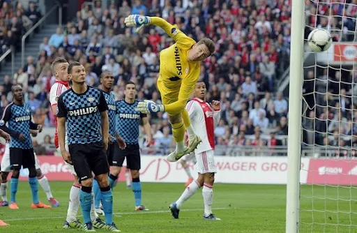 PSV goalkeeper Przemysław Tytoń fails to save a goal by Ajax player Ismaïl Aissati