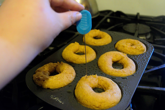 The fully baked pumpkin donuts being tested for doneness. 