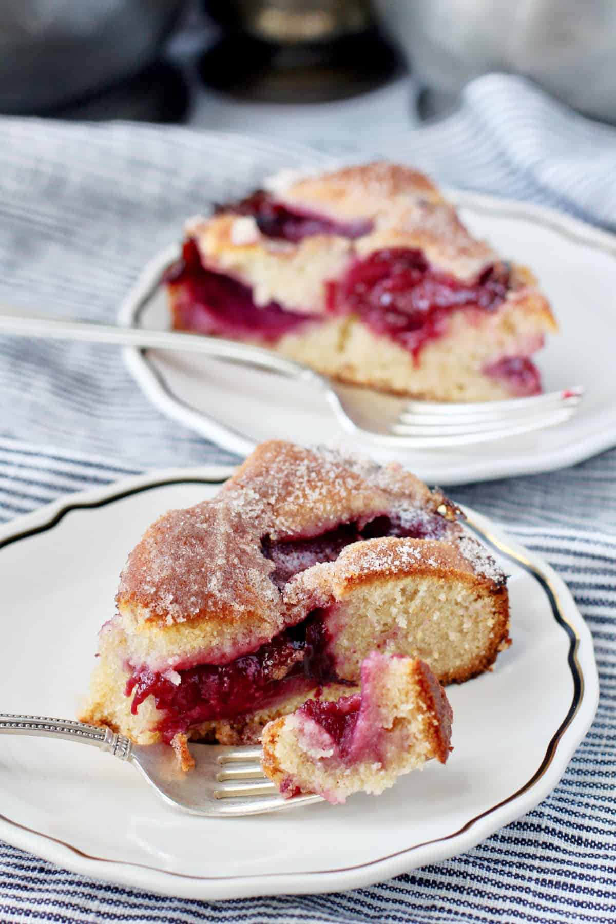 Plum Cake Baked with a bite on a fork on a plate.