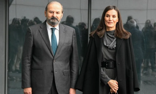 Queen Letizia wore a long scarf collar dress by Adolfo Domínguez. Letizia wore a wool black coat by Nina Ricci. Black suede boots