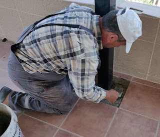 Bekir sticking the tiles down