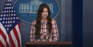 Olivia stepped up to the mic wearing a matching pink plaid blazer and skirt to deliver her quick message.