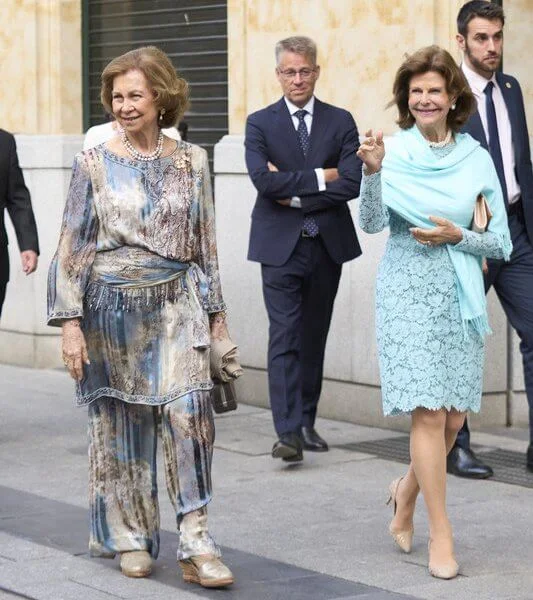 Queen Sofia and Queen Silvia attended a concert in Salamanca. Silvia wore a lace dress, Sofia wore a floral print silk jumpsuit