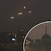 'It's an alien invasion' Glowing UFOs hover above skyscrapers in amazing footage