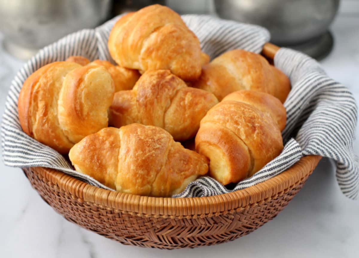 Flaky Buttery Crescent Rolls in a basket.
