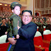 North Korean leader Kim Jong Un holds up a child