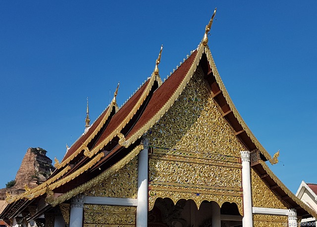 Elaborate golden facade of the Viharn near the entrance to temple complex.