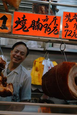 Image of Cantonese BBQ pork being sold from a small store in an alley, in Hong Kong.