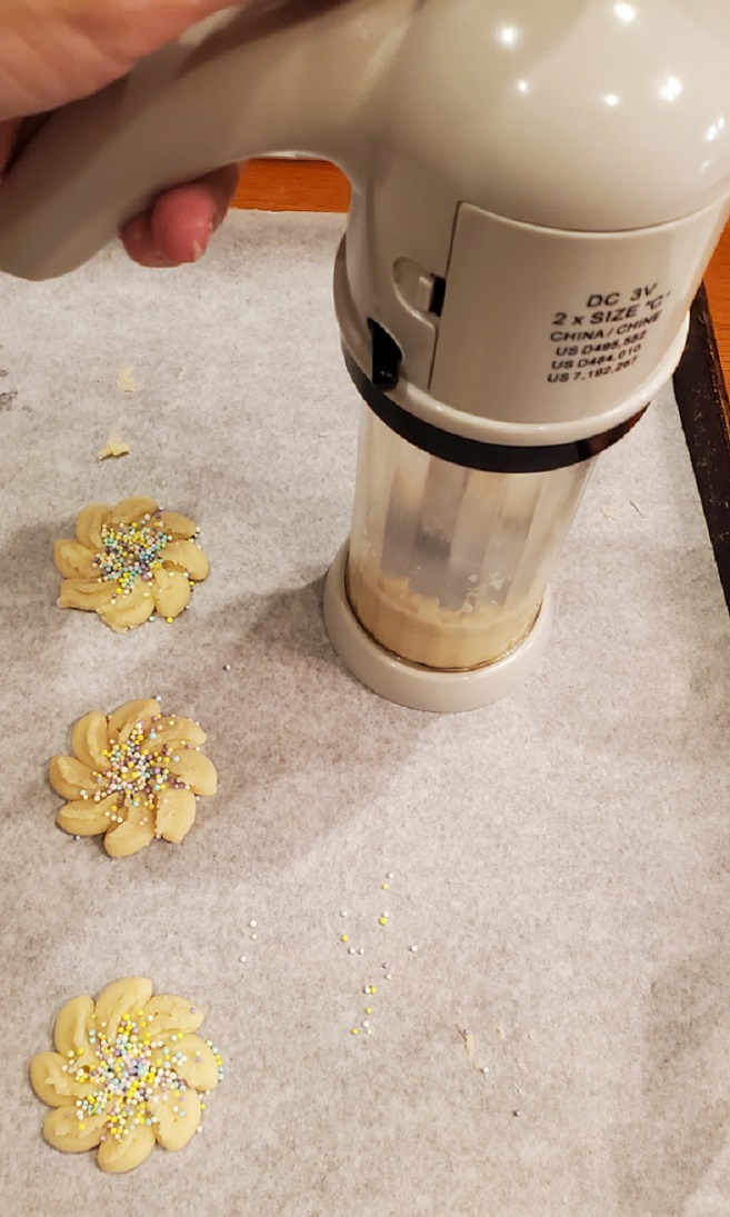 this is a cookie press making extruded flower cookies