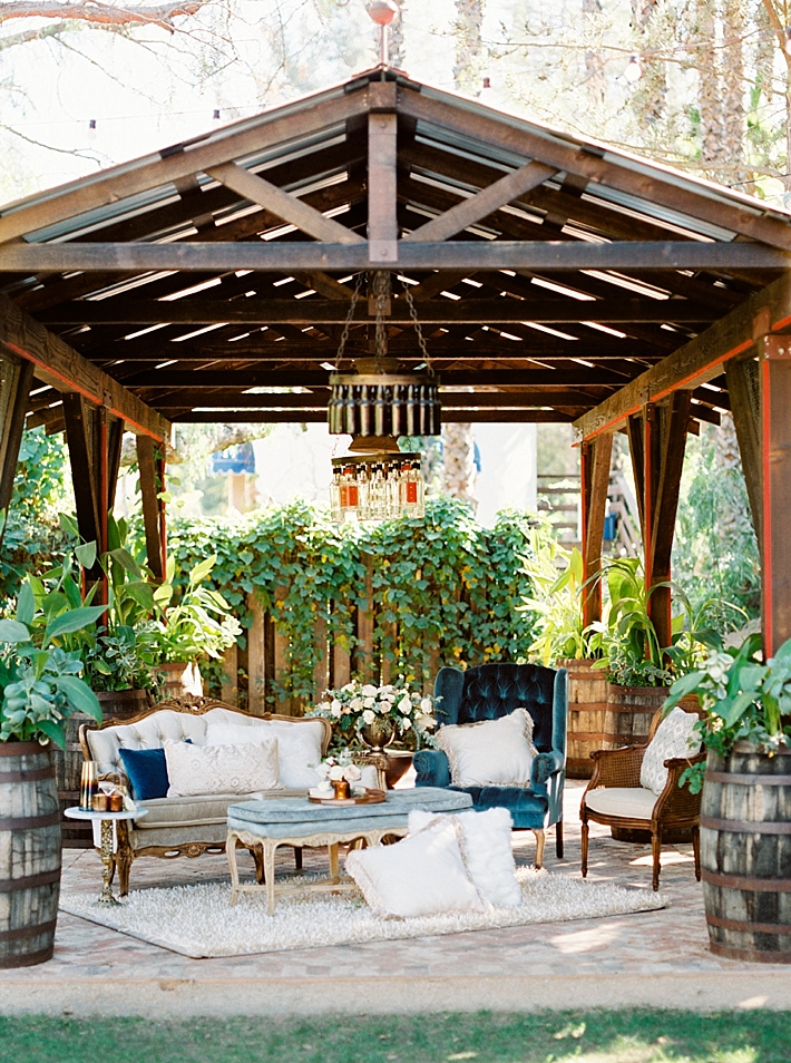 Chic blue and white lounge seating area with shaggy rug and pillows | Photo by Dennis Roy Coronel | See more on thesocalbride.com