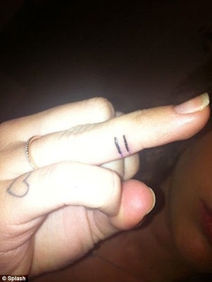 on her middle finger