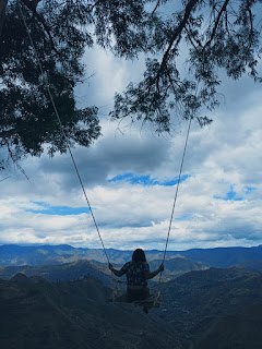 Girl on swing with a view of Loja, Ecuador