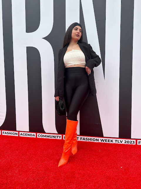 Woman in leggings, bandeau top and orange boots