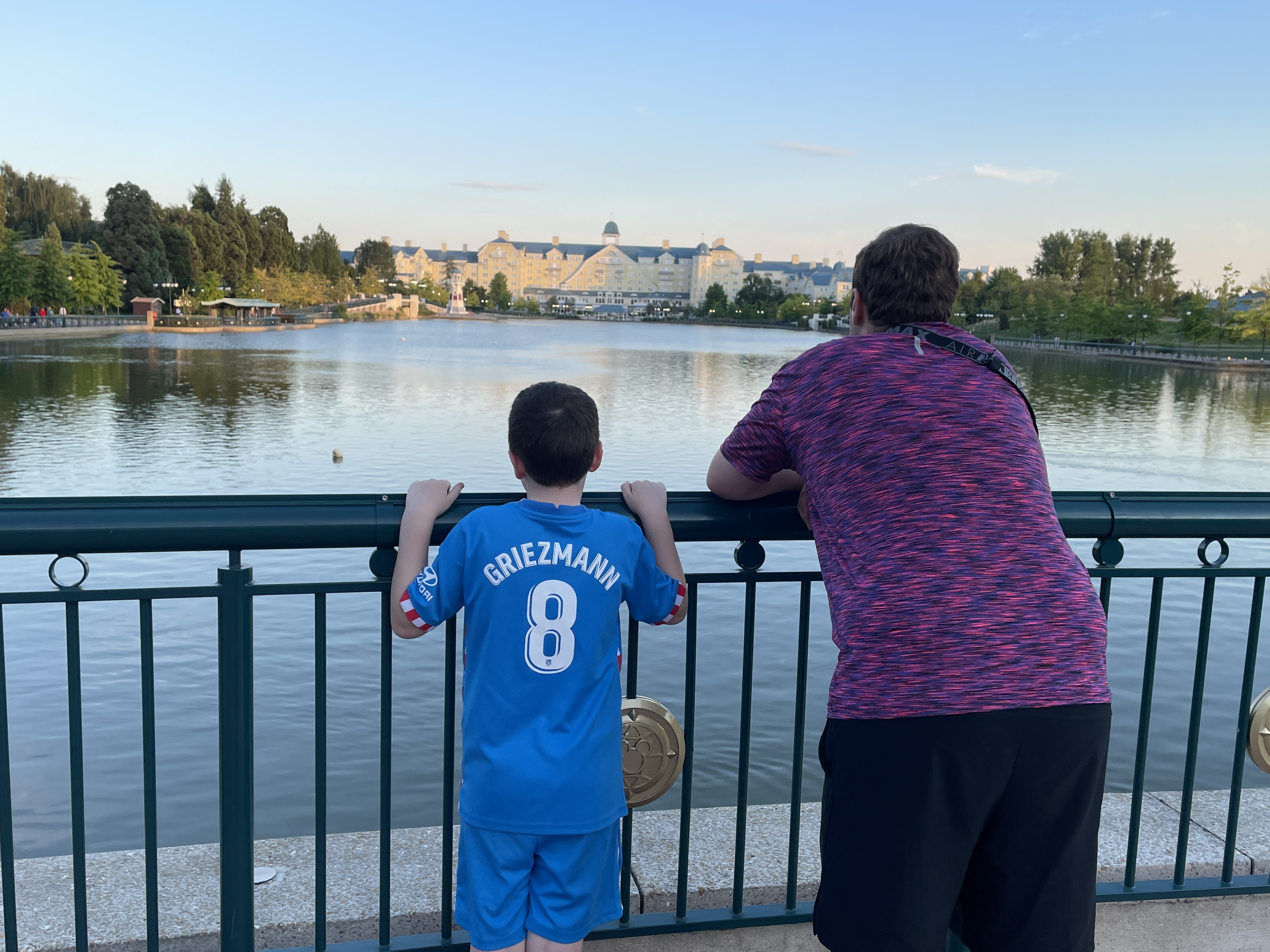 two boys overlooking a lake
