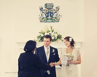 bride and groom receiving their marriage certificate at Marylebone Town Hall wedding
