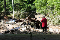 Emma Allen, 58, looks at the remnants of her damaged home after flooding in Falling Rock, West Virginia. (Credit: Marcus Constantino / Reuters) Click to Enlarge.