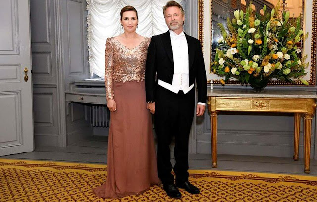 Crown Princess Mary wore a grey cape sleeve silk gown by Valentino. Danish Prime Minister Mette Frederiksen