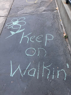 Chalk writing on sidewalk:  Keep on Walkin'