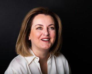 Head and shoulders photo of author Cristina Loggia - woman with shoulder length light brown hair