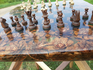 A detailed shot of the side of the handmade chess table, made from pine cones.