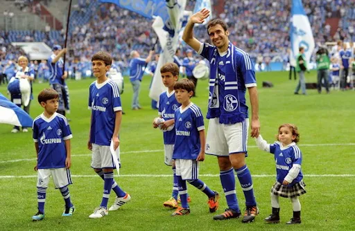 Departing Spain striker Raúl waves goodbye to the Schalke fans with his family