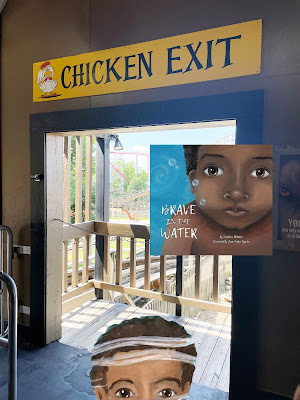 A cartoon of the top half of a head of a dark-skinned boy with black hair peeks into a photograph of a non-cartoon doorway with a rollercoaster in the background. Above the doorway is a sign that says "Chicken Exit."