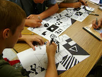 students around a table working on an art project