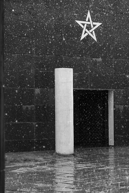 A Minimalist Photo of a Star Sign at Jawahar Kala Kendra as seen from the entrance gate during a Rain shower.
