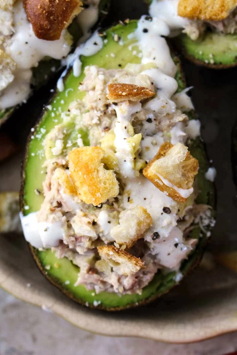 Caesar Tuna Stuffed Avocados make a delicious lunch or light dinner. The combination of tuna, avocado, and Caesar dressing is insanely good! #tuna #avocados #Caesar