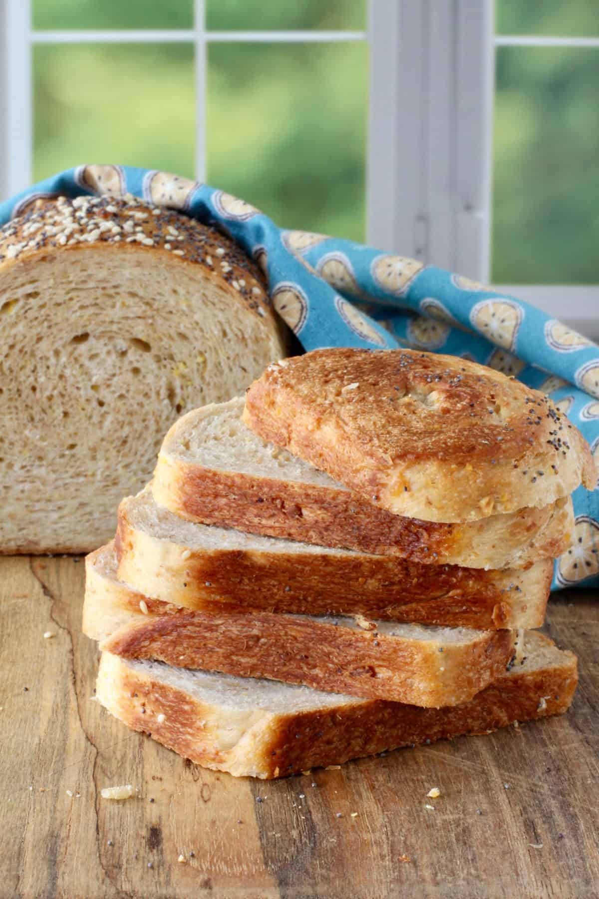Peter Reinhart's Struan Bread slices stacked in front of a half loaf.
