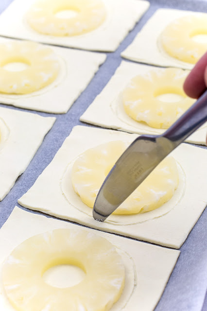 Pineapple puff pastry dessert before baking knife 