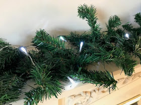 Adding fairy lights to a fireplace garland