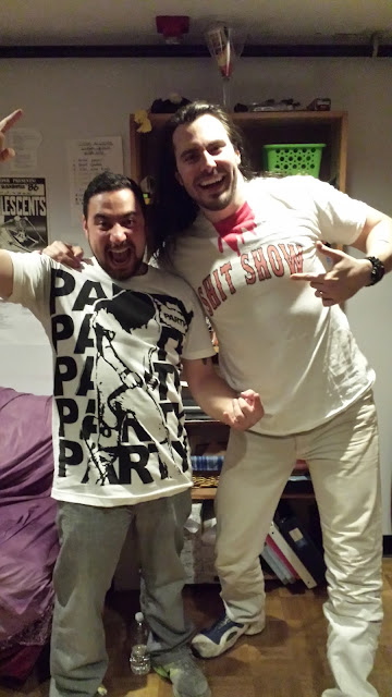 Josh and Andrew W.K. wearing each others' merchandise