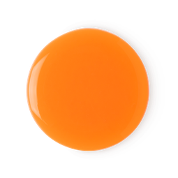 A oval orange ehaped puddle of shower gel on a bright background