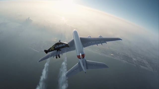 Men with Jetpacks Fly with a Giant Plane Over Dubai Sky