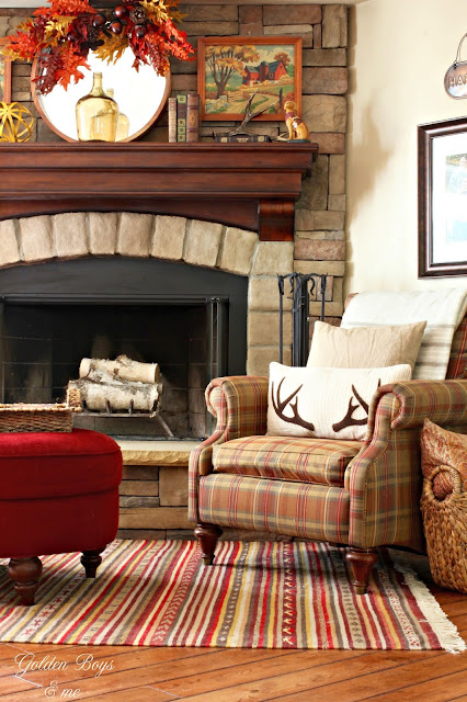 Stone fireplace with fall decor.  Vintage paint by numbers, Ikea rug, Birch Lane stag antler pillow-www.goldenboysandme.com