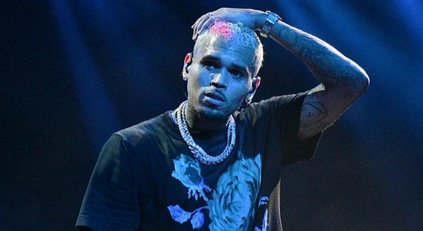 Chris Brown stares at four walls of a grotty police cell in Manchester