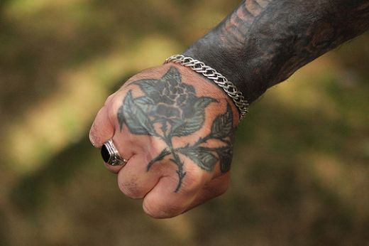 Another guy with a black rose tattoo this time right on the top of the hand