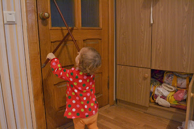 small girl playing with stick like a drummer girl