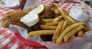 Fish basket with fries and hush puppies.